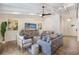 Bright and airy living room featuring wood floors, a ceiling fan, and comfortable seating at 305 73Rd St, Holmes Beach, FL 34217