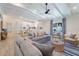 Open-concept living space with beamed ceilings, wood floors, and an adjacent modern kitchen at 305 73Rd St, Holmes Beach, FL 34217