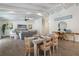 Bright, open-concept living room with wood floors, beamed ceilings, and a comfortable dining area at 305 73Rd St, Holmes Beach, FL 34217