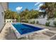 Private backyard with a pool surrounded by lush tropical landscaping at 305 73Rd St, Holmes Beach, FL 34217