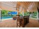 Spacious outdoor kitchen area with a pool view, perfect for grilling and entertaining at 315 N Bay Blvd, Anna Maria, FL 34216