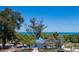 Beautiful view of the beach from the rooftop with blue skies and lush green trees in the distance at 315 N Bay Blvd, Anna Maria, FL 34216