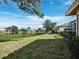 Landscaped backyard overlooking a tranquil lake, offering a serene outdoor space at 3835 Alamanda Dr, Sarasota, FL 34238
