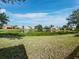 Lush backyard featuring a tranquil pond and well-maintained landscaping in a serene neighborhood setting at 3835 Alamanda Dr, Sarasota, FL 34238