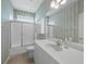 Bathroom featuring a shower/tub combo, a vanity with a sink, and blue wallpaper at 3835 Alamanda Dr, Sarasota, FL 34238