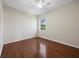 This bedroom features hardwood floors, a ceiling fan, and a window providing natural light at 3835 Alamanda Dr, Sarasota, FL 34238