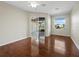 Spacious bedroom boasts hardwood floors, a ceiling fan, and sliding glass doors to the lanai at 3835 Alamanda Dr, Sarasota, FL 34238
