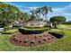 Mira Lago community entrance sign surrounded by landscaping and palm trees at 3835 Alamanda Dr, Sarasota, FL 34238