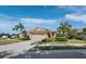 Charming single-story home featuring lush landscaping, a tile roof, and an attached two-car garage at 3835 Alamanda Dr, Sarasota, FL 34238