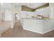Well-lit kitchen featuring white cabinetry, granite countertops, and stainless steel appliances at 3835 Alamanda Dr, Sarasota, FL 34238