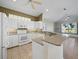 Bright kitchen with white cabinets, granite countertops, and a convenient breakfast bar open to the living spaces at 3835 Alamanda Dr, Sarasota, FL 34238