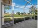 Enjoy relaxing on the screened-in lanai with a view of the serene lake and community at 3835 Alamanda Dr, Sarasota, FL 34238
