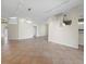 Bright and open living room with tile flooring leading to the kitchen and featuring neutral walls at 3835 Alamanda Dr, Sarasota, FL 34238