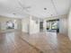 Spacious living room featuring tile flooring, modern lighting fixtures, and sliding glass doors to the lanai at 3835 Alamanda Dr, Sarasota, FL 34238
