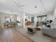Bright living room with neutral decor, dining area, tile flooring, and seamless access to the outdoor living space at 3835 Alamanda Dr, Sarasota, FL 34238
