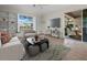 Cozy living room with lake views, built-in shelving, and easy access to the outdoor patio area at 3835 Alamanda Dr, Sarasota, FL 34238