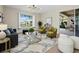 Cozy living room offers ample natural light, plush seating, stylish decor and access to outdoor space at 3835 Alamanda Dr, Sarasota, FL 34238