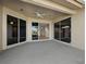 Spacious outdoor patio with sliding glass doors, perfect for entertaining and enjoying the tranquil surroundings at 3835 Alamanda Dr, Sarasota, FL 34238