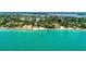 Coastal aerial of beachfront homes with turquoise waters, palm trees, and sandy shoreline at 4050 Higel Ave, Sarasota, FL 34242