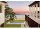 Inviting backyard showcasing a rectangular pool, manicured lawn, and partial ocean view at 4050 Higel Ave, Sarasota, FL 34242