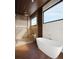 Luxurious bathroom featuring a standalone tub, spacious walk-in shower, and contemporary fixtures in this home at 4050 Higel Ave, Sarasota, FL 34242