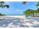 A beach view showcases two blue chairs sitting in the sand near a tranquil ocean at 4050 Higel Ave, Sarasota, FL 34242