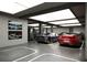 Spacious garage showcasing luxury vehicles, custom lighting, and art for the car enthusiast at 4050 Higel Ave, Sarasota, FL 34242