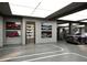 Spacious garage showcasing luxury vehicles, custom lighting, and art for the car enthusiast at 4050 Higel Ave, Sarasota, FL 34242