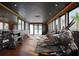 Well-equipped home gym with modern exercise machines, weights, and ample natural light at 4050 Higel Ave, Sarasota, FL 34242