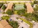 Aerial view of condo community featuring tennis courts, parking, and convenient access to nearby amenities at 4061 Crockers Lake Blvd # 2618, Sarasota, FL 34238