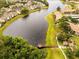 Scenic aerial view of lakeside condo community featuring lush landscaping, walking paths, and private dock at 4061 Crockers Lake Blvd # 2618, Sarasota, FL 34238