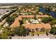 Overhead view showcasing the community pool, lush landscaping, and parking at 4061 Crockers Lake Blvd # 2618, Sarasota, FL 34238