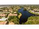 An aerial view of community homes surrounding a beautiful, winding lake at 4061 Crockers Lake Blvd # 2618, Sarasota, FL 34238