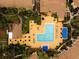 A nice community pool is surrounded by lounge chairs, blue umbrellas, and tropical foliage at 4061 Crockers Lake Blvd # 2618, Sarasota, FL 34238