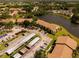 Wide aerial view highlighting the community, lush landscaping, and scenic pond at 4061 Crockers Lake Blvd # 2618, Sarasota, FL 34238