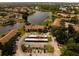 Aerial view of condo buildings with parking and boat storage, set against a tranquil lake backdrop at 4061 Crockers Lake Blvd # 2618, Sarasota, FL 34238
