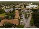 Aerial view of a lakeside community featuring mature landscaping and multiple buildings at 4061 Crockers Lake Blvd # 2618, Sarasota, FL 34238