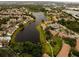 Aerial view of a community nestled around a serene lake, showcasing lush landscaping at 4061 Crockers Lake Blvd # 2618, Sarasota, FL 34238