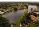 Aerial view of a lakeside community featuring multiple buildings, a pier, and mature trees at 4061 Crockers Lake Blvd # 2618, Sarasota, FL 34238