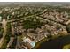 Aerial view of a community, highlighting the pool, lake and surrounding landscape at 4061 Crockers Lake Blvd # 2618, Sarasota, FL 34238