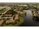 A stunning aerial view featuring residences adjacent to a lake and golf course at 4061 Crockers Lake Blvd # 2618, Sarasota, FL 34238