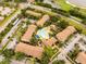 An aerial view shows well maintained homes surrounding a pristine community pool at 4061 Crockers Lake Blvd # 2618, Sarasota, FL 34238