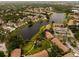 A beautiful aerial view of residences on a lake, surrounded by green lush vegetation at 4061 Crockers Lake Blvd # 2618, Sarasota, FL 34238