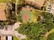 Aerial view of community basketball court surrounded by mature trees and well-maintained landscaping at 4061 Crockers Lake Blvd # 2618, Sarasota, FL 34238