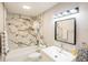 Updated bathroom features marble tile, updated vanity, and modern lighting at 4061 Crockers Lake Blvd # 2618, Sarasota, FL 34238