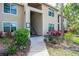 Tan condominium building with lush landscaping at 4061 Crockers Lake Blvd # 2618, Sarasota, FL 34238