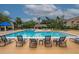 Community pool with lounge chairs for relaxation in a sunny environment at 4061 Crockers Lake Blvd # 2618, Sarasota, FL 34238