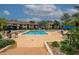 Large community pool surrounded by lounge chairs and tables at 4061 Crockers Lake Blvd # 2618, Sarasota, FL 34238