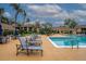 Community pool surrounded by lounge chairs and palm trees with buildings in the background at 4061 Crockers Lake Blvd # 2618, Sarasota, FL 34238