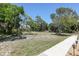 Expansive green lawn with mature trees, offering plenty of space and natural beauty at 4169 66Th Street W Cir # 4169, Bradenton, FL 34209